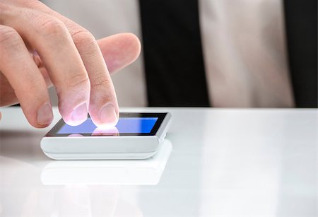 Man pointing at touch screen on a white office table. Stockbilder - Microstock & Abonnement, Bildnummer: 400-06951977