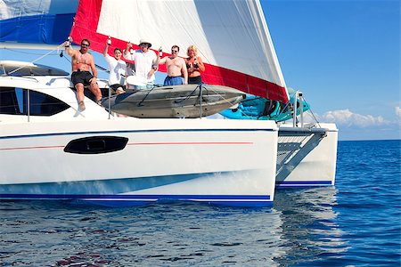 parties boats - Sailboat in the open sea with sailing crew partying on the deck Stock Photo - Budget Royalty-Free & Subscription, Code: 400-06952409