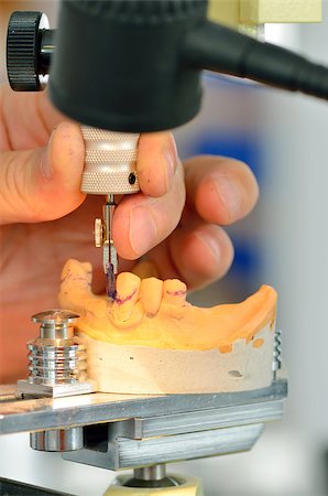 Dental technician measuring dentures in laboratory Stockbilder - Microstock & Abonnement, Bildnummer: 400-06952433