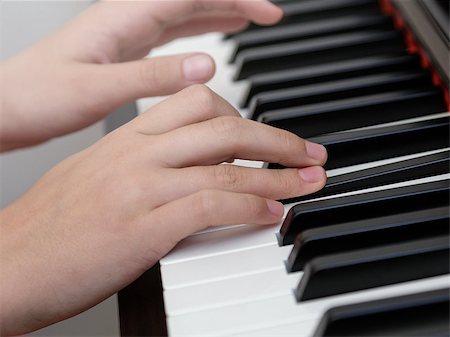 photo of girls hands playing on piano, shallow depth of field Stock Photo - Budget Royalty-Free & Subscription, Code: 400-06953024