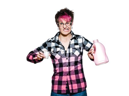Trendy young woman with an angry expression holding detergent in studio on white isolated background Stock Photo - Budget Royalty-Free & Subscription, Code: 400-06953322