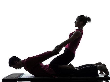 full body massage - one man and woman performing thai massage in silhouette studio on white background Foto de stock - Super Valor sin royalties y Suscripción, Código: 400-06953357
