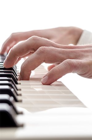 simsearch:400-06329491,k - Closeup of pianist playing digital piano isolated over white background. Stock Photo - Budget Royalty-Free & Subscription, Code: 400-06953460