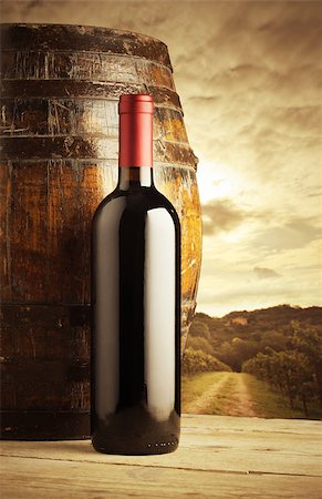 simsearch:400-07829164,k - red wine bottle and wodden barrel, vineyard on background Stock Photo - Budget Royalty-Free & Subscription, Code: 400-06953516