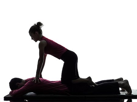 full body massage - one man and woman performing thai massage in silhouette studio on white background Foto de stock - Super Valor sin royalties y Suscripción, Código: 400-06953807