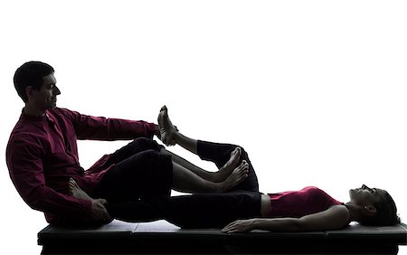 full body massage - one man and woman performing feet legs thai massage in silhouette studio on white background Foto de stock - Super Valor sin royalties y Suscripción, Código: 400-06953808