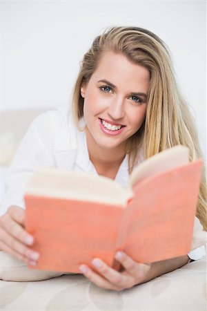 simsearch:693-07542343,k - Smiling gorgeous model lying on cosy bed in bright bedroom reading book Stock Photo - Budget Royalty-Free & Subscription, Code: 400-06960005