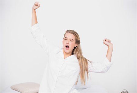 simsearch:693-07542343,k - Yawning cute model stretching in cosy bed in bright bedroom Stock Photo - Budget Royalty-Free & Subscription, Code: 400-06960035