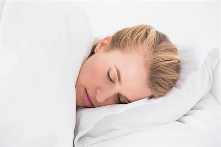 simsearch:693-07542343,k - Pretty model sleeping in cosy bed in bright bedroom Stock Photo - Budget Royalty-Free & Subscription, Code: 400-06960037