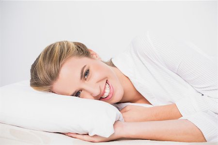 simsearch:693-07542343,k - Smiling cute model lying on cosy bed in bright bedroom Stock Photo - Budget Royalty-Free & Subscription, Code: 400-06960033