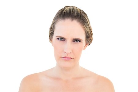 simsearch:400-06960125,k - Portrait of woman looking angry at camera against white background Photographie de stock - Aubaine LD & Abonnement, Code: 400-06960042