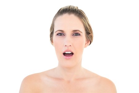 simsearch:400-06960125,k - Portrait of shocked woman looking at camera against white background Photographie de stock - Aubaine LD & Abonnement, Code: 400-06960043