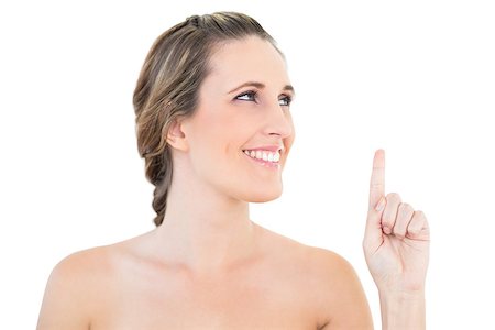 simsearch:400-06960125,k - Cheerful woman pointing and looking up on white background Photographie de stock - Aubaine LD & Abonnement, Code: 400-06960062