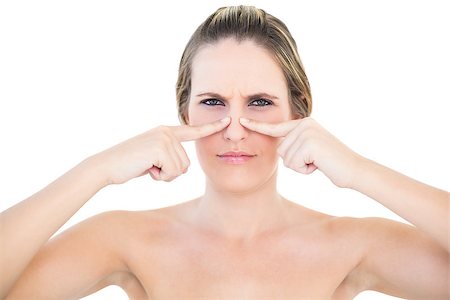 simsearch:400-06960125,k - Pretty woman pressing blackhead on her nose posing on white background Photographie de stock - Aubaine LD & Abonnement, Code: 400-06960071