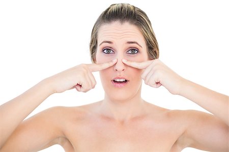 simsearch:400-06960125,k - Shocked woman pressing blackhead on her nose posing on white background Photographie de stock - Aubaine LD & Abonnement, Code: 400-06960072