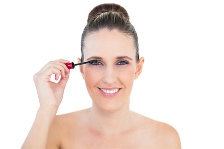 simsearch:400-06960125,k - Young woman applying mascara posing on white background Photographie de stock - Aubaine LD & Abonnement, Code: 400-06960107