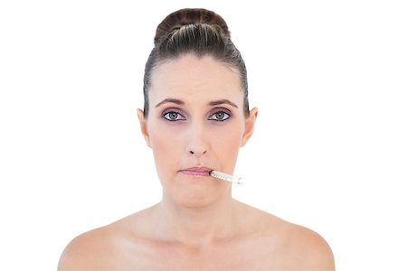 simsearch:400-06960125,k - Sick woman with thermometer on mouth looking at camera against white background Photographie de stock - Aubaine LD & Abonnement, Code: 400-06960115