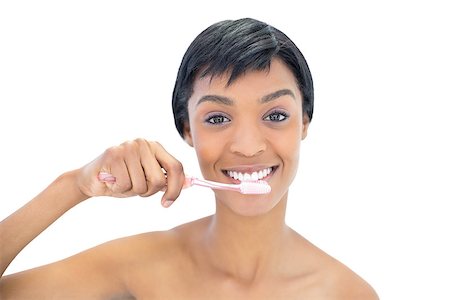 perfect white teeth - Charming black haired woman brushing her teeth on white background Stock Photo - Budget Royalty-Free & Subscription, Code: 400-06960585