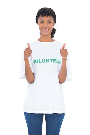 Charming black haired volunteer giving thumbs up on white background Stock Photo - Budget Royalty-Free & Subscription, Code: 400-06960645