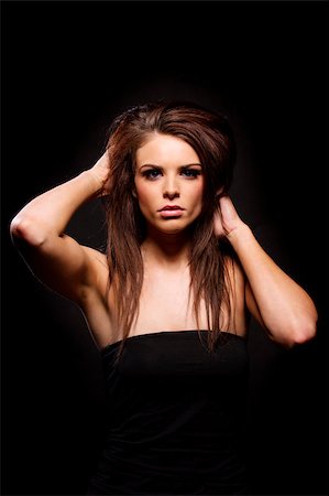 simsearch:400-04873499,k - Gorgeous brunette woman looking at the camera on a black background Stock Photo - Budget Royalty-Free & Subscription, Code: 400-07035674
