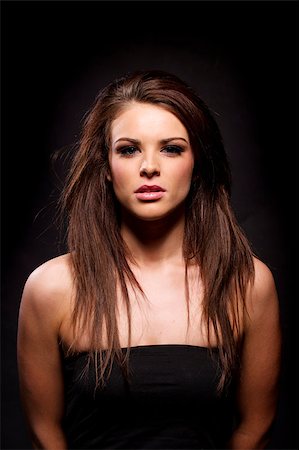 simsearch:400-04873499,k - Gorgeous brunette woman looking at the camera on a black background Stock Photo - Budget Royalty-Free & Subscription, Code: 400-07035671