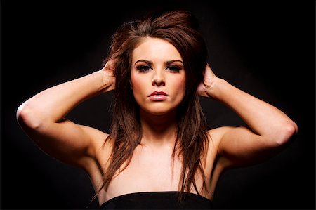 simsearch:400-04873499,k - Gorgeous brunette woman looking at the camera on a black background Stock Photo - Budget Royalty-Free & Subscription, Code: 400-07035673