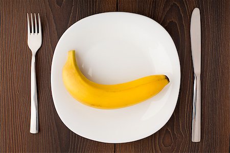 simsearch:400-07036577,k - Banana on a white plate with fork and knife Stock Photo - Budget Royalty-Free & Subscription, Code: 400-07035737