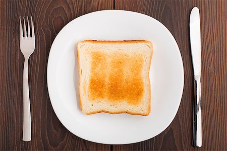 simsearch:400-07036577,k - Toast on white plate on a table Stock Photo - Budget Royalty-Free & Subscription, Code: 400-07036574