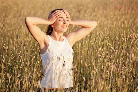 Outdoor portrait of a woman on a meadow releaxing Stock Photo - Budget Royalty-Free & Subscription, Code: 400-07037109