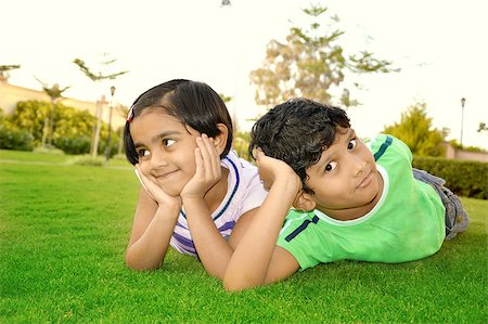 Cheerful south Asian boy and girl in a lawn Stock Photo - Budget Royalty-Free & Subscription, Code: 400-07044491