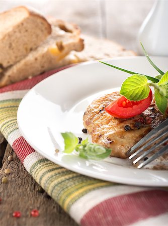 restaurant steak - Nourishing steak on grill with tomatoes and bread on a wooden table Stock Photo - Budget Royalty-Free & Subscription, Code: 400-07044530