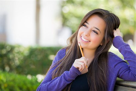 Attractive Pensive Mixed Race Female Student with Pencil Sitting on Campus Bench. Stock Photo - Budget Royalty-Free & Subscription, Code: 400-07045751