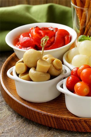 pickled snacks (tapas) - mushrooms, tomatoes, cucumbers and pearl onions Photographie de stock - Aubaine LD & Abonnement, Code: 400-07045789
