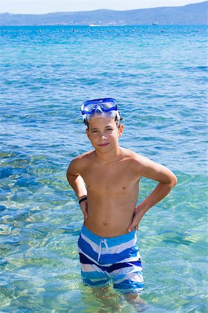 Cute eleven years old boy staying in the sea Stockbilder - Microstock & Abonnement, Bildnummer: 400-07045941