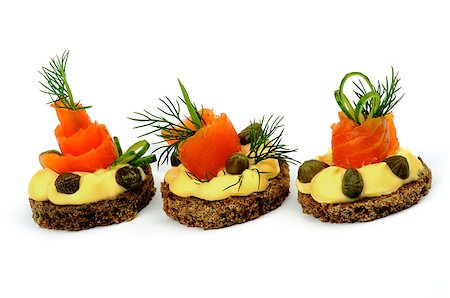 simsearch:400-07039898,k - Delicious Snacks with Smoked Salmon, Greens, Cheese Cream and Capers In a Row isolated on white background. Horizontal View Foto de stock - Royalty-Free Super Valor e Assinatura, Número: 400-07046294