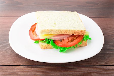 plate of cold cuts and cheeses - Sandwich with ham, cheese and tomato on a plate Stock Photo - Budget Royalty-Free & Subscription, Code: 400-07046339