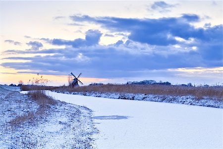 simsearch:400-07046539,k - Dutch windmill by frozen river in winter at sunrise Stock Photo - Budget Royalty-Free & Subscription, Code: 400-07046515