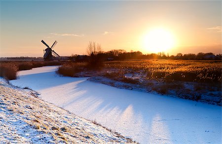 sunrise over Dutch windmill and frozen canal, Groningen Stockbilder - Microstock & Abonnement, Bildnummer: 400-07046518