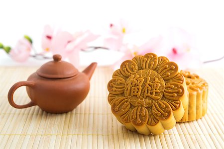 Chinese mid autumn festival foods. Traditional mooncakes on table setting with teapot. The Chinese words on the mooncakes means durian pure lotus paste, not a logo or trademark. Stock Photo - Budget Royalty-Free & Subscription, Code: 400-07047176