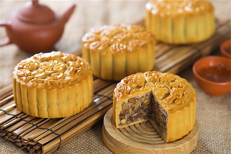 Chinese mid autumn festival foods. Traditional mooncakes on table setting.  The Chinese words on the mooncakes means assorted fruits nuts, not a logo or trademark. Stock Photo - Budget Royalty-Free & Subscription, Code: 400-07047184