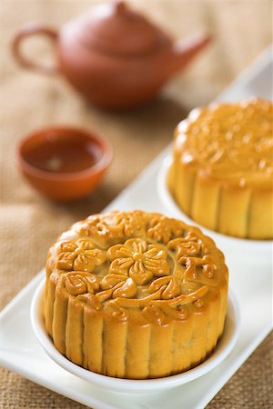 Chinese mid autumn festival foods. Traditional mooncakes on table setting with teapot.  The Chinese words on the mooncakes means assorted fruits nuts, not a logo or trademark. Stock Photo - Budget Royalty-Free & Subscription, Code: 400-07047186