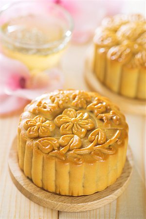 simsearch:400-05754691,k - Chinese mid autumn festival foods. Traditional mooncakes on table setting with flower tea.  The Chinese words on the mooncakes means assorted fruits nuts, not a logo or trademark. Foto de stock - Super Valor sin royalties y Suscripción, Código: 400-07047188