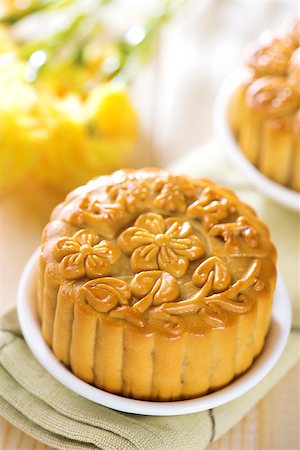 Traditional mooncakes on table setting.  Chinese mid autumn festival foods. The Chinese words on the mooncakes means assorted fruits nuts, not a logo or trademark. Stock Photo - Budget Royalty-Free & Subscription, Code: 400-07047189