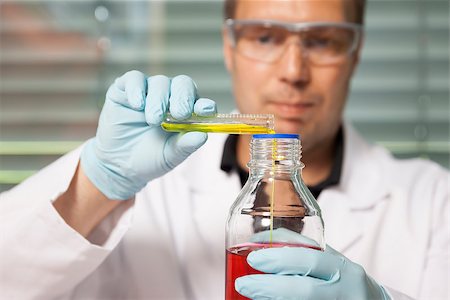A man with red and yellow liquid in a laboratory Stock Photo - Budget Royalty-Free & Subscription, Code: 400-07048469