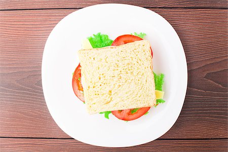 plate of cold cuts and cheeses - Sandwich with ham, cheese and tomato on a plate Stock Photo - Budget Royalty-Free & Subscription, Code: 400-07048749