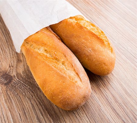 Baguette in paper bag on a wooden background Stock Photo - Budget Royalty-Free & Subscription, Code: 400-07048743