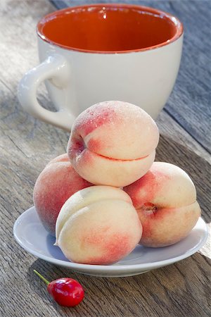 simsearch:400-07061592,k - Ripe peaches berry of dogwood and a cup on old wooden background Stock Photo - Budget Royalty-Free & Subscription, Code: 400-07048762