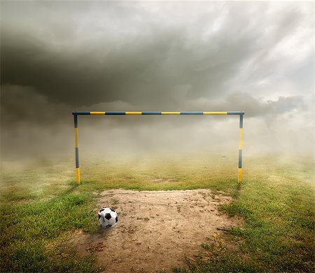 Football field, football goal, deflated ball and cloudy sky Stockbilder - Microstock & Abonnement, Bildnummer: 400-07049986