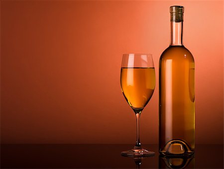 simsearch:400-04935153,k - Bottle and glass of white wine on a brown background Photographie de stock - Aubaine LD & Abonnement, Code: 400-07040324