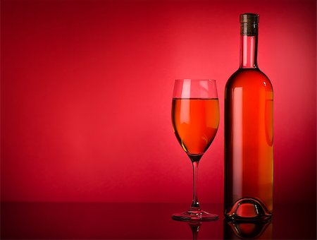 Buttle and glass of white wine on a red background Stockbilder - Microstock & Abonnement, Bildnummer: 400-07040325